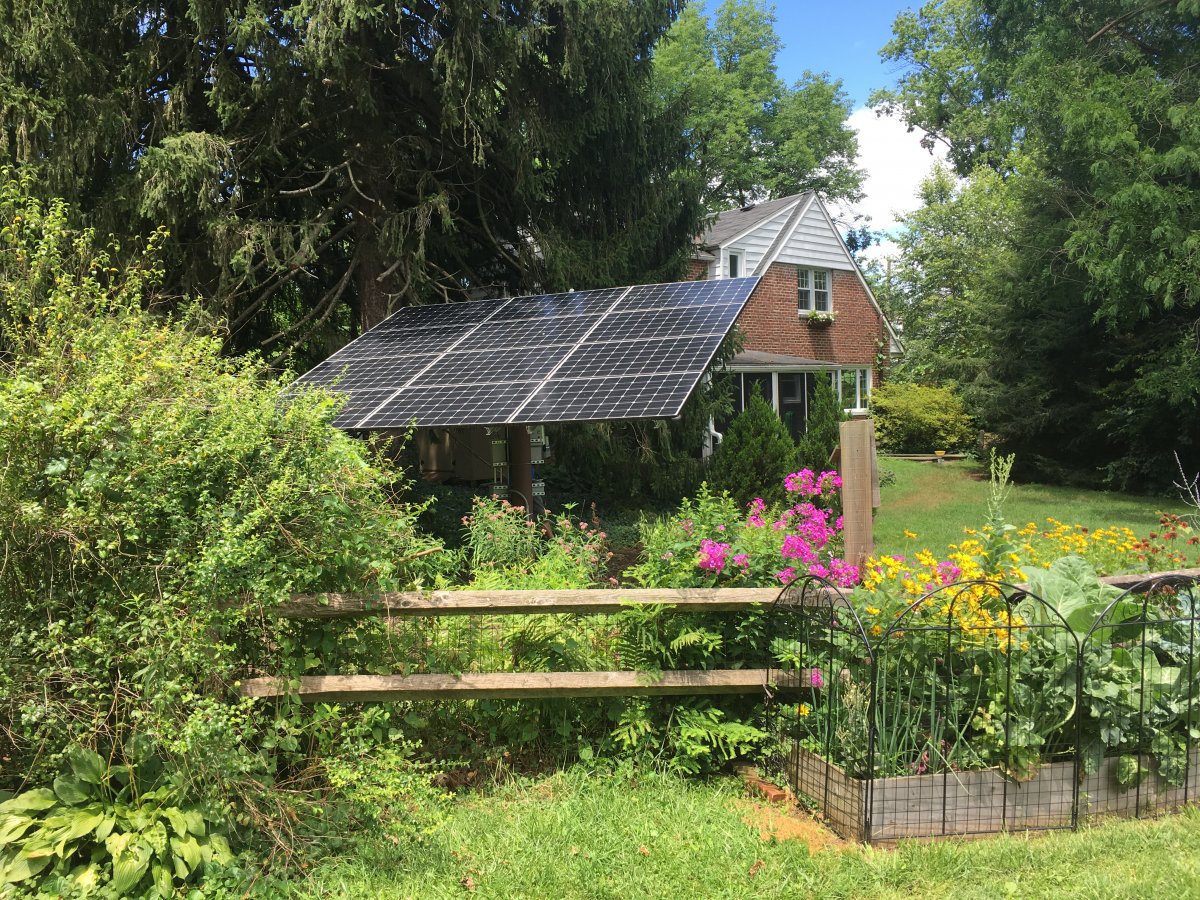 Solar ground mount system out of sight in homeowners backyard 